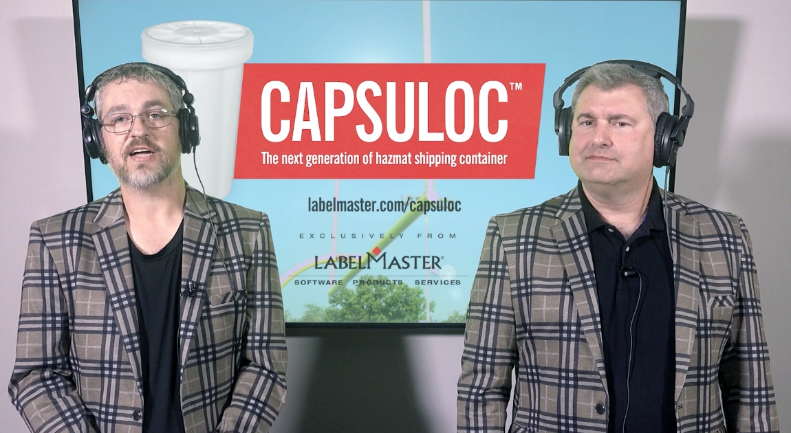 Capsuloc “Kick The Can” video: Two announcers in front of screen.