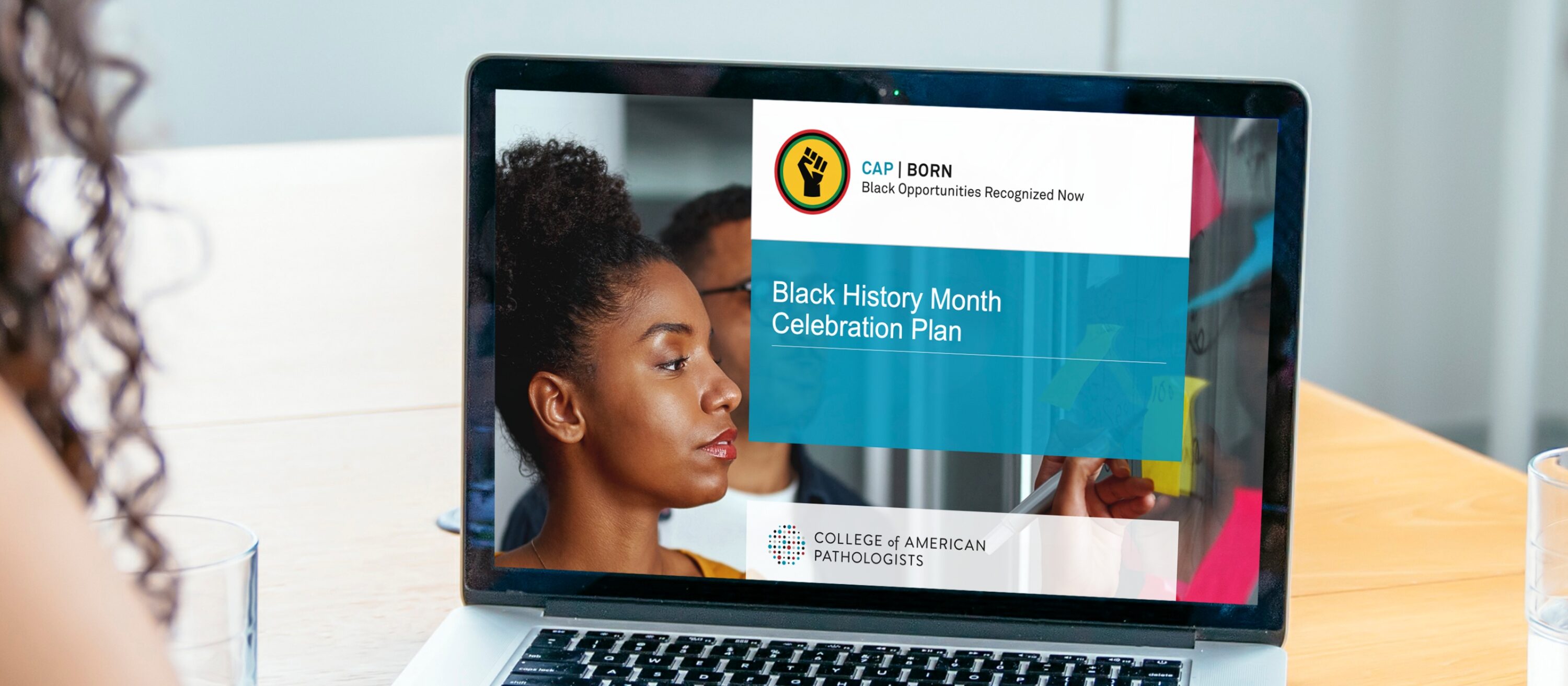Laptop displaying a Black History Month Celebration Plan with CAP BORN branding.