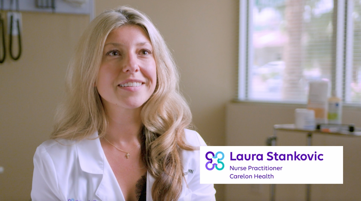 Nurse practitioner Laura Stankovic smiling in a clinical exam room, identified with Carelon Health branding.