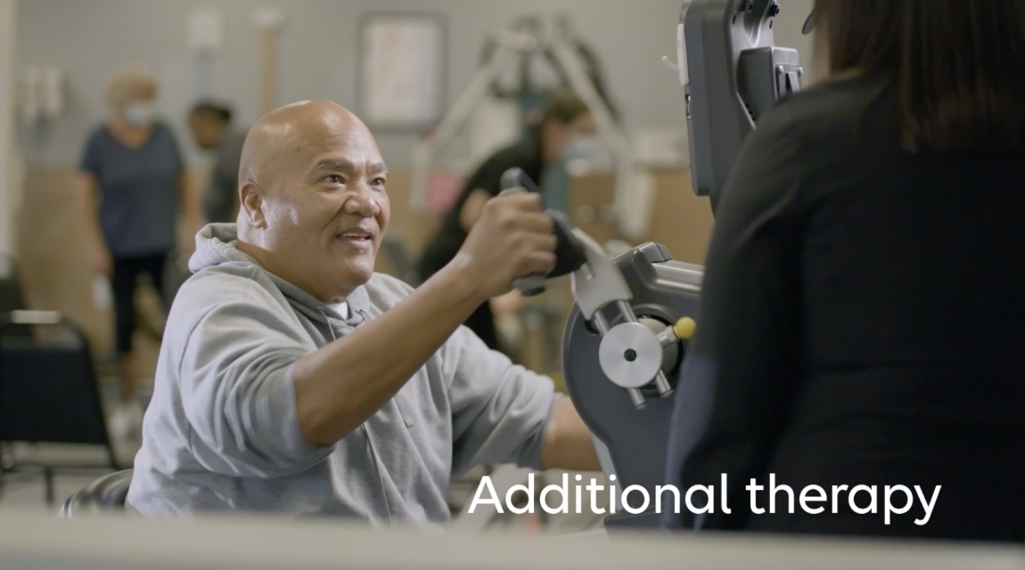Patient performing strength exercise on therapy equipment with guidance during a rehabilitation session.