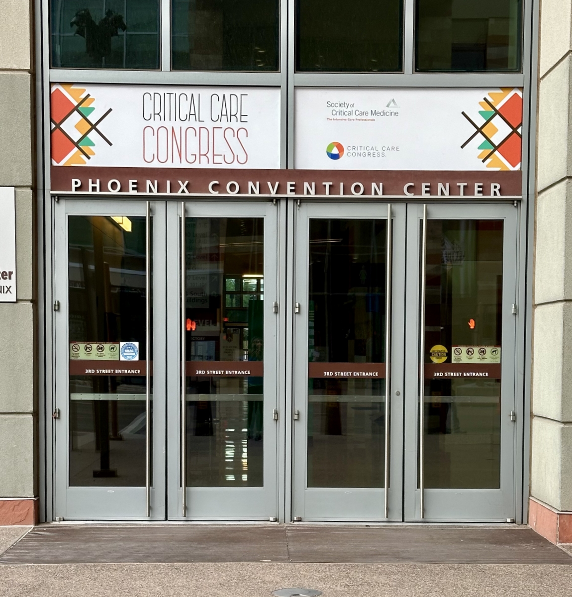Critical Care Congress: Window signage for the event above exterior entry doors.